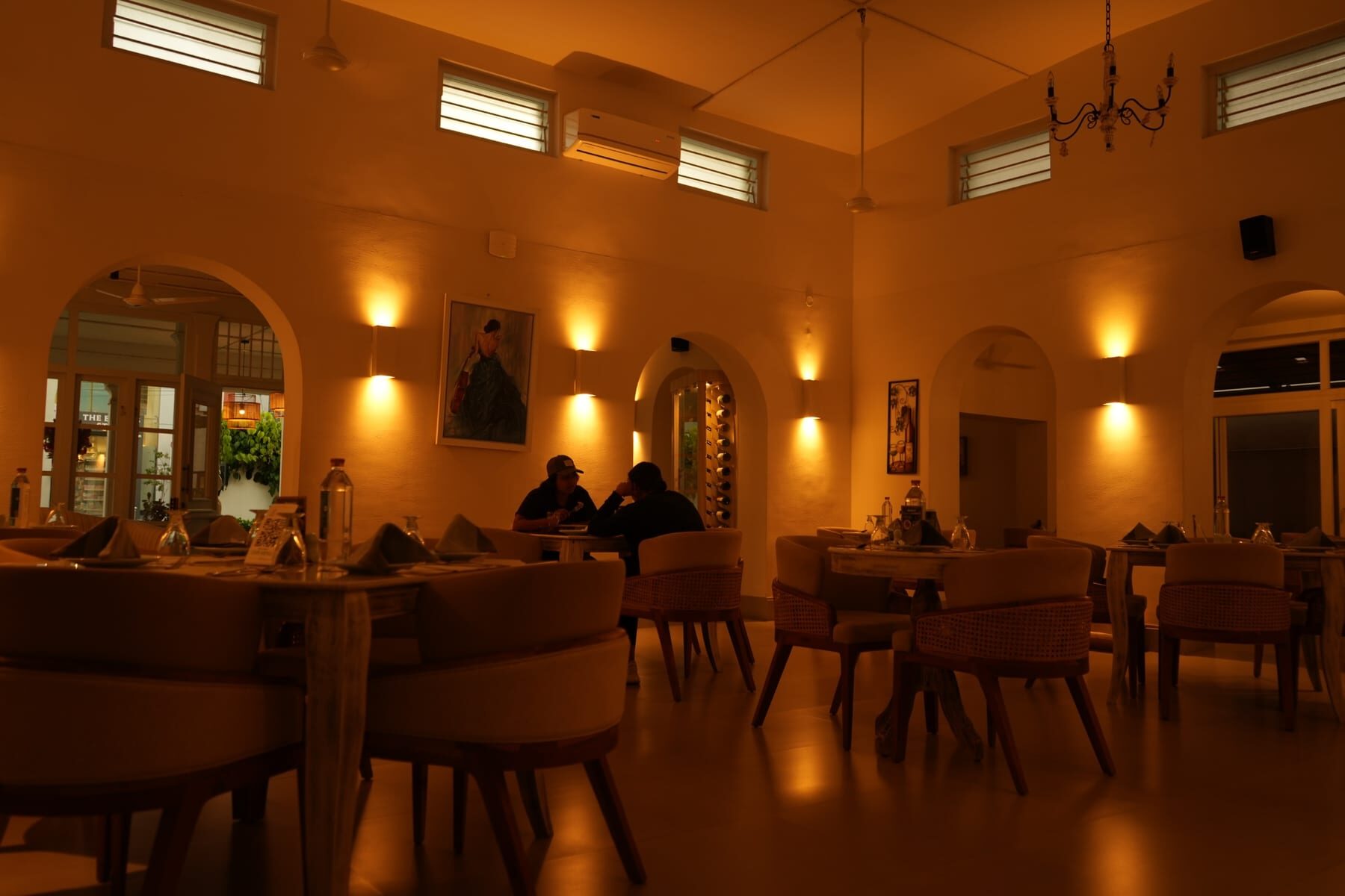 The warm, candle-lit dining hall at The Sorrento, Mysuru